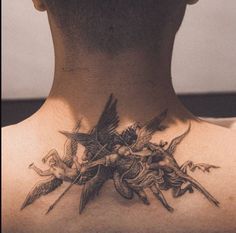 the back of a man's neck is adorned with birds and flowers on it