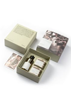 an open box containing two bottles and some cards