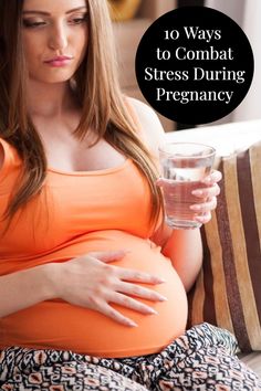 a pregnant woman holding a glass of water