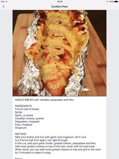 an image of food in tin foil on a wooden table with the caption, garlic bread and cheesy pizza