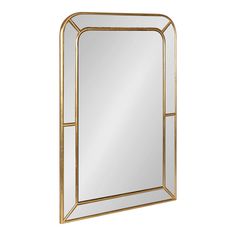 a gold framed mirror on a white background with the reflection of an arched window in it