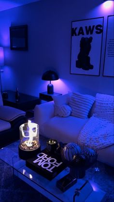 a living room filled with furniture and blue lighting