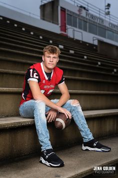 a young man in a football uniform sitting on some steps