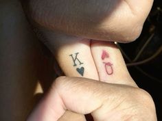 two people with matching tattoos on their fingers