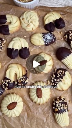 a table topped with lots of different types of cookies and pastries on top of wax paper