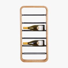 three bottles of wine on a wooden rack