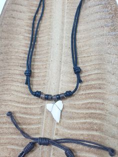 Surfer necklace and adjustable leather bracelet with Shark Tooth / For men and women, unisex / Minimalist hippie jewelry / Beach necklace Authentic shark tooth with natural pearls. Photos serve as an example only, each tooth is unique and differs slightly in shape and size from the photo. Shark fangs have long been known for their symbolic meaning of bravery, strength, power and protection. Ancient Hawaiians wore shark tooth necklaces to ward off danger and protect them while at sea. Sharks lose Hippie Jewelry With Adjustable Cord For Gift, Hippie Jewelry With Adjustable Cord As Gift, Hippie Style Jewelry With Adjustable Cord For Gifts, Hippie Style Jewelry With Adjustable Cord As Gift, Casual Adjustable Chain Jewelry For Friendship, Casual Beach Necklace With Sliding Knot, Bohemian Jewelry With Adjustable Clasp For Gifts, Bohemian Jewelry With Adjustable Clasp As Gift, Bohemian Jewelry As A Gift With Adjustable Clasp