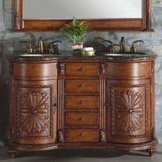 a bathroom vanity with two sinks and a large mirror over the top that has a plant in it