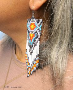 Our Best Design!Bright Desert Color Native American Style Seed Bead Earrings Native Designed Hand Made Powwow Regalia Earrings Free Shipping . Stainless steel ear wires for you safety. Beautiful Desert color mix with an authentic Native American Design great for matching favorite regalia or wearing alone. Super length for maximum exposure! As always... Free Shipping from Hawaii with Aloha! (Please be advised that this item has been copyrighted in all color combinations ©HE Hawaii 2021) White Southwestern Beaded Earrings For Festivals, Southwestern White Beaded Earrings For Festival, White Southwestern Style Beaded Earrings For Festival, White Southwestern Beaded Earrings, Southwestern Style White Earrings For Festivals, Southwestern Style White Beaded Dangle Earrings, White Round Bead Southwestern Earrings, White Beaded Southwestern Earrings, Southwestern Style Beaded White Earrings