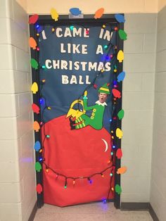 a door decorated to look like a christmas ball with an elf riding on the top