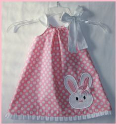 a pink and white polka dot dress with a bunny applique