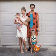 a man, woman and child are dressed up as the flintman and his wife