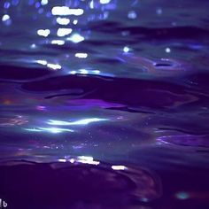 the water is blue and purple with some light reflecting off it's surface,