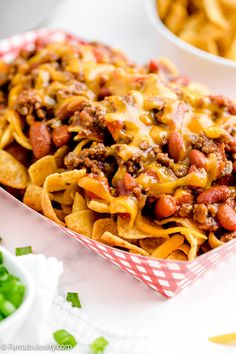 this chili cheese nachos is loaded with ground beef and beans