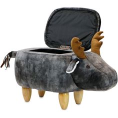 a stuffed animal sitting in a suitcase on top of a wooden stool with its mouth open