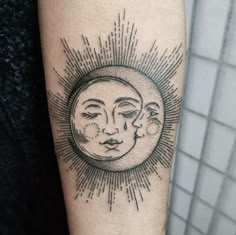 a sun and moon tattoo on the arm