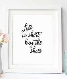 a white framed print with the words life is short buy the shoes