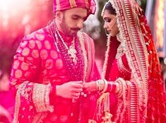 the bride and groom are looking at each other while they stand together in front of an audience