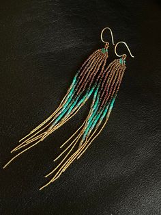 "Maui Swan Designs beautiful, delicate earrings. Czech Glass Seed Beads hand sewn with nylon thread. 5.5\" long delicate earrings incorporating rich earthy deep golden bronze tones, transparent, iridescent, sea foam, teal, 24k gold and silver lined glass seed beads. 21\" total of 14k gold filled chain fringe Hand made 14kt gold filled ear wire. Amazing in all lights! Original Maui Swan design. These are stunning & tiny enough u won't feel them on your ears & super shiny!!" Swan Design, Chain Fringe, Silver Line, Wire Wrapped Earrings, Seed Bead Earrings, Delicate Earrings, Sterling Silver Hoops, Fringe Earrings, Gorgeous Earrings