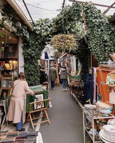 an outdoor market with people shopping and selling items