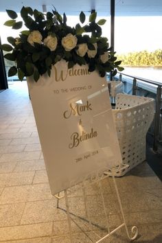 a welcome sign with flowers on it in front of a balcony area at a hotel