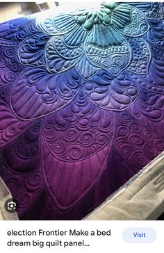 an intricately designed purple and blue quilt