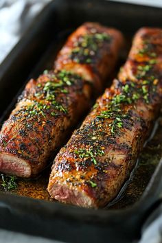 Two seasoned, grilled steaks garnished with herbs on a black tray. Pork Tenderloin Recipes In Oven With Potatoes, Tenderloin Dinner Ideas, Pork Tenderloin Dishes, Pork Tenderloin Dinner Ideas, Baked Pork Tenderloin Recipes, Stuffed Pork Tenderloin Recipes, Pork Tenderloin Recipes In Oven, Pork Tenderloin Dinner, Pork Loin Recipes Oven