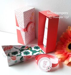 two boxes and one flower are sitting on the table next to it's packaging