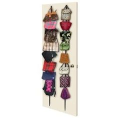 a wall mounted rack with many purses on it