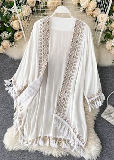 White V Neck Tassel Cardigan Long SleeveFabric: Cotton BlendedSize & Fit: Fit: This garment fits true to size.Length: Size 2XL measures 30.42"from shoulder to hemBust: Great for any cup size. Waist: Loose Fit. Comfortable room throughout midsection.Hip: Loose Fit - room for hips. Hand Wash Cold. Tassel Shirt, Poncho Cardigan, Cardigan Long Sleeve, Embroidered Cardigan, Boho Kimono, Cardigan Long, Lightweight Cardigan, Embroidery Fashion, Knitted Cardigan