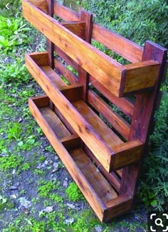 a wooden bench sitting on top of a lush green field