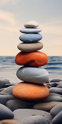 a stack of rocks sitting on top of the ocean