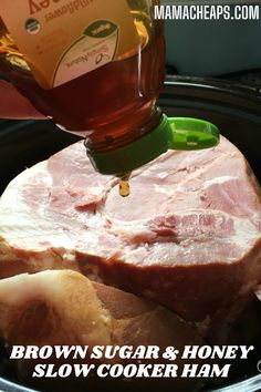 a bottle of brown sugar and honey is being poured into a slow cooker ham