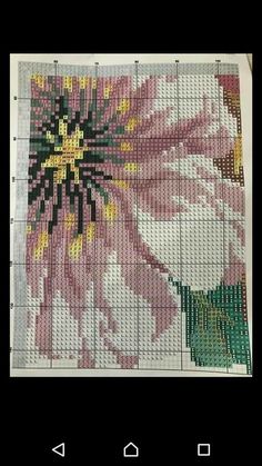 a cross stitch pattern with flowers and leaves on the bottom, as well as an image of