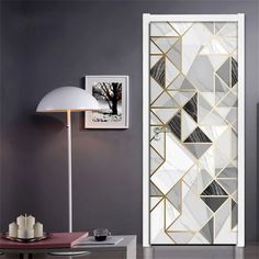 the door is decorated with gold and white geometric designs on it's glass panels