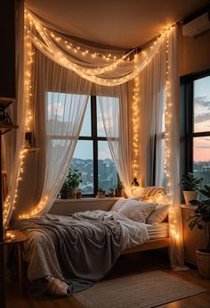 a bedroom with lights strung from the ceiling and curtains on the window sill over the bed