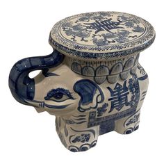 an elephant shaped ceramic container with blue and white designs on it's lid,