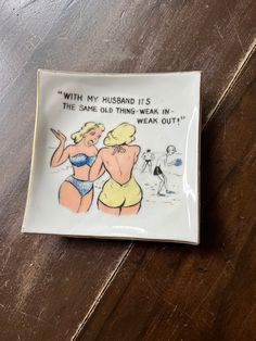 a ceramic plate with an image of two women in bathing suits on the front and back