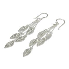 Cascading leaves from sterling stems. Wadarat Supasirisuk fashions these earrings from silver, that dance like diminutive wind chimes. Sterling silver Hook earrings Handmade in & fairly traded from Thailand Cheap Nickel-free Dangle Earrings, Cheap Silver Dangle Wrap Earrings, Cheap Adjustable Dangle Wrap Earrings, Affordable Elegant Sterling Silver Wrap Earrings, Cheap Festive Dangle Danglers, Cheap Metal Danglers For Gift, Elegant Handmade Cheap Danglers, Cheap Metal Danglers For Gifts, Ribbon Jewelry