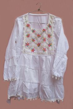 Handmade- Yes Neck - Round-Neck Sleeve Style - Long Sleeve Fit - Regular Fabric - Cotton Blend Type - Short Kurti Belt Included - Yes Pattern - Solid Color - White Pack of - 1 Fabric Care - Dry Clean Only Size - M (US 8-10, UK 12-14) bust: 91-96 cm / 36"-38" waist: 72-77 cm / 28.5"-30.5" hips: 98-103 cm / 38.5"-40.5" Size - L (US 12-14, UK 16-18) bust: 97-103 cm / 38.5"-40.5" waist: 78-84 cm / 31"-33" hips: 104-110 cm / 41"-43" Note - To Go Direct Our Home page Please Click Below- https://www.et Bohemian Dresses With Woven Motifs For Eid, Bohemian Dresses With Multicolor Embroidery For Navratri, Bohemian Dresses With Embroidered Border For Navratri, Traditional V-neck Boho Dress For Spring, Bohemian Navratri Dresses With Embroidered Border, Bohemian V-neck Embroidered Top, Folk Style Embroidered Dress For Festive Season, Fitted Bohemian Embroidered Dress For Navratri, Festive White Kaftan With Woven Motifs