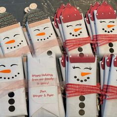 snowmen are wrapped in white paper with red ribbon