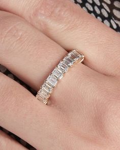 a woman's hand with a diamond ring on it