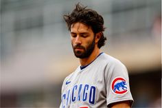 a close up of a baseball player wearing a uniform with chicago cubs logo on it