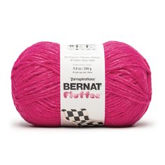 the yarn ball is bright pink with black and white checkerboard design on it