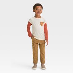 Whether you're getting them ready for preschool or taking them out on errands, keep your little one comfortable in these Woven Jogger Pants from Cat & Jack™. Designed in a relaxed-leg silhouette, these mid-rise jogger pants are crafted from midweight twill fabric for all-day cozy comfort. They're designed with reinforced knees, and they feature a full elastic waistband with a drawstring closure to help them find a secure fit. Showcasing a solid color and ribbed cuffs, they also have side and bac Cotton Pants For Playwear In Fall, Fall Cotton Playwear Pants, Fall Cotton Pants For Playwear, Fall Playwear Cotton Pants, Casual Fall Playtime Bottoms, Casual Fall Bottoms For Playtime, Cotton Pants For Playtime In Fall, Playful Cotton Pants For Fall, Casual Pants For Playtime In Fall