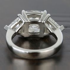 a diamond ring sitting on top of a wooden table