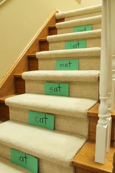 a set of stairs with words written on the carpet to spell out what they are