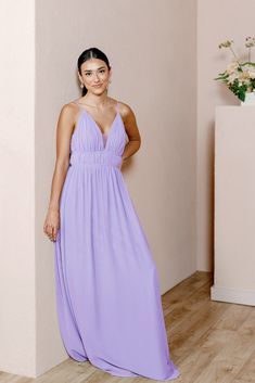 a woman in a purple dress posing for the camera