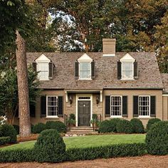 a house that has hedges in front of it