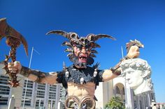 a man in an elaborate costume holding two large metal arms and claws with his hands